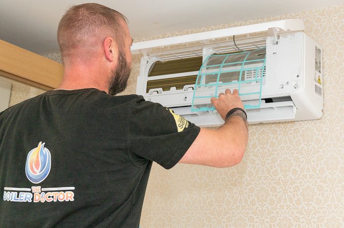 Engineer fitting an air conditioning indoor unit at a York property
