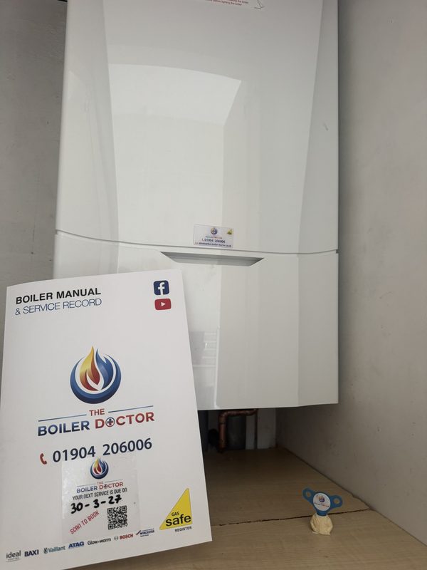 Completed boiler installation with The Boiler Doctor's service record folder