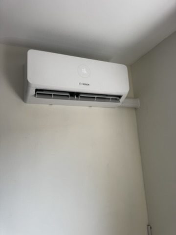 Clean indoor air conditioning unit installed on a plain wall