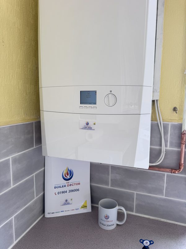 Finished boiler installation with a Boiler Doctor branded mug